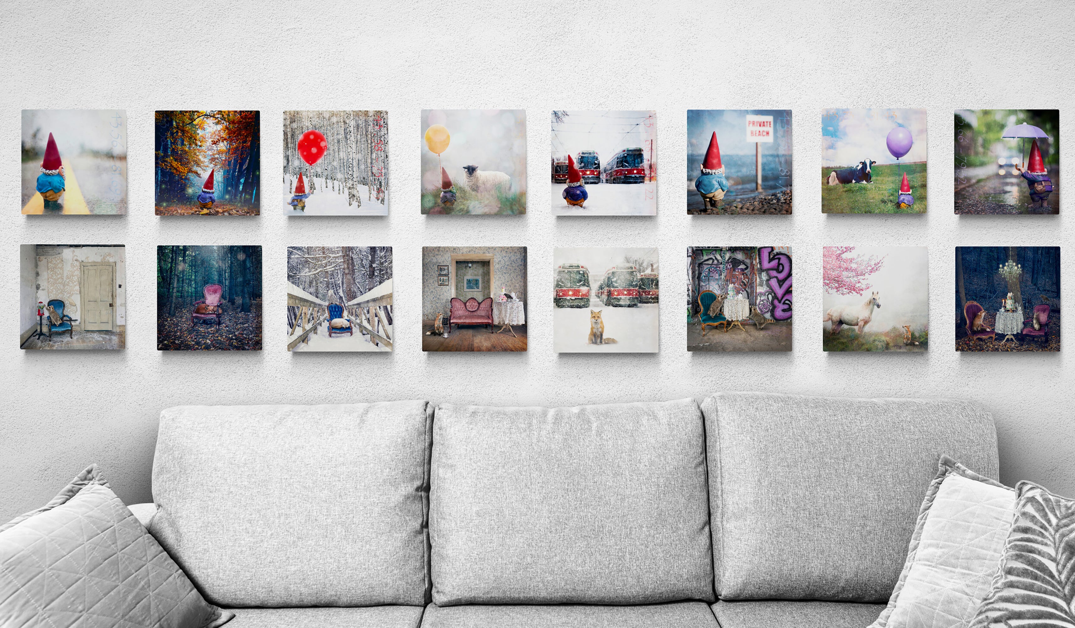 Paintings hung in a grid over a couch.